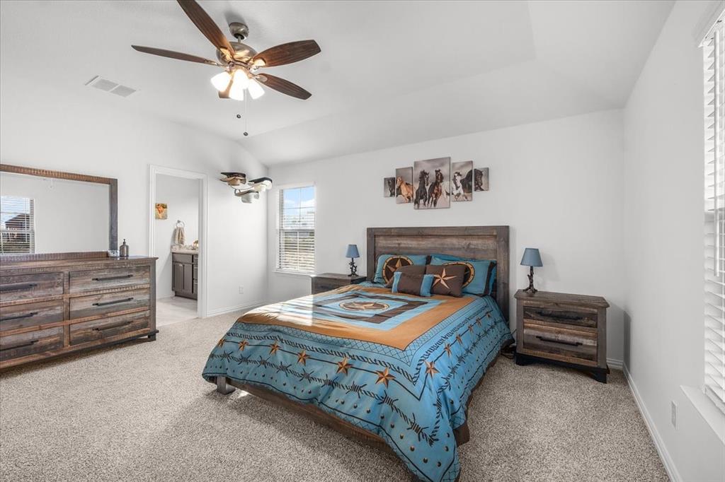 3797 Pine Road Poolville, TX 76487 - Photo 10 of 22 a bedroom with a bed and a chandelier