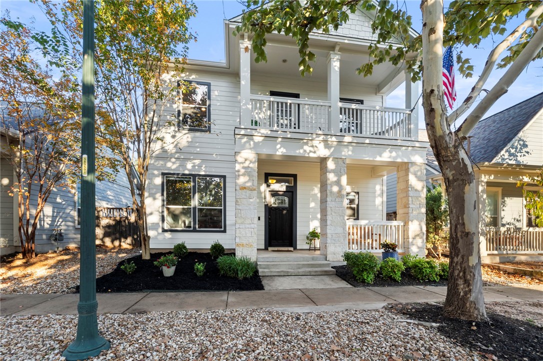 a front view of a building with a garden