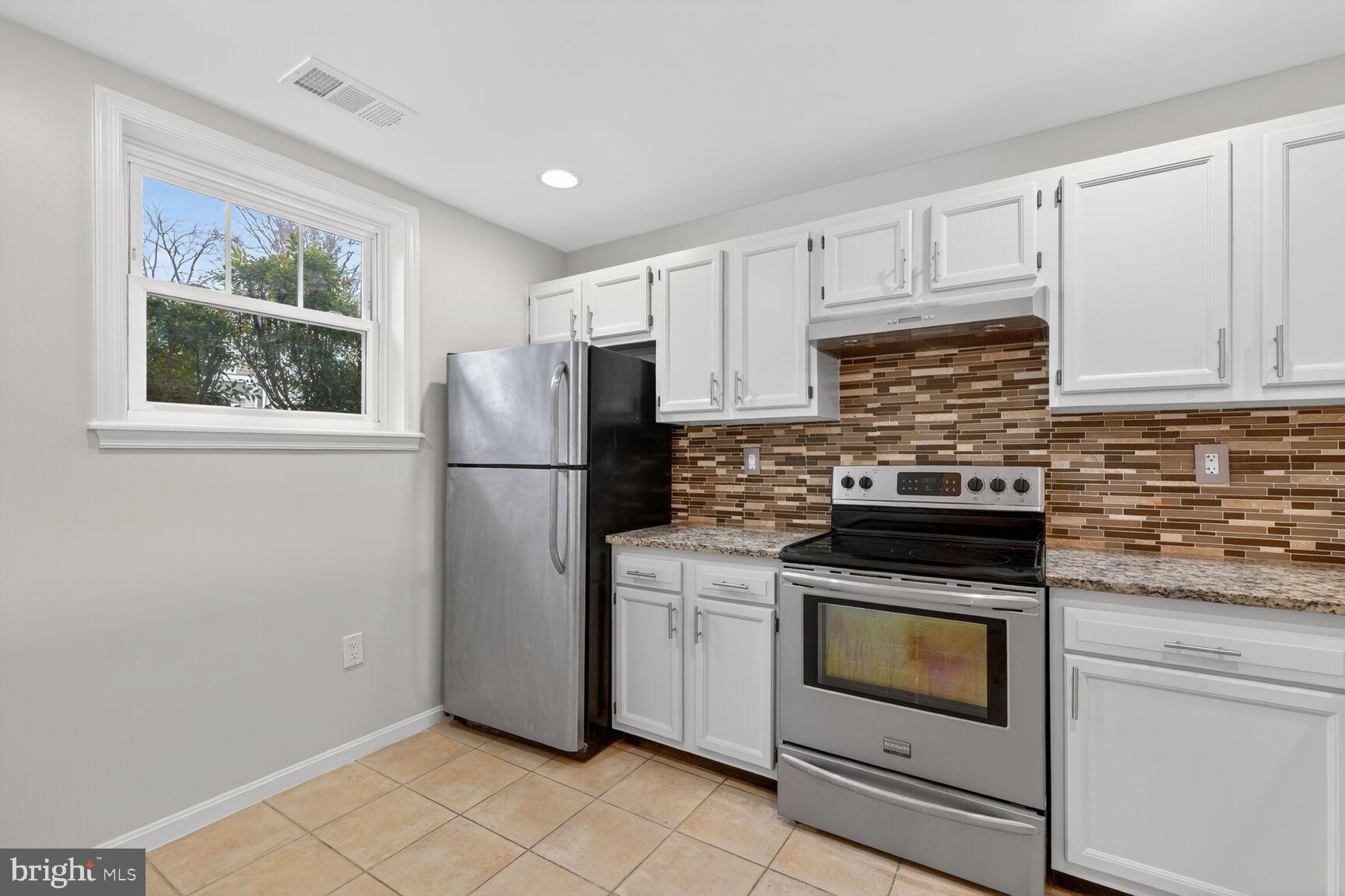 3854 9th Road South, Unit 3854 Arlington, VA 22204 - Photo 11 of 31 a kitchen with stainless steel appliances white cabinets and a stove top oven