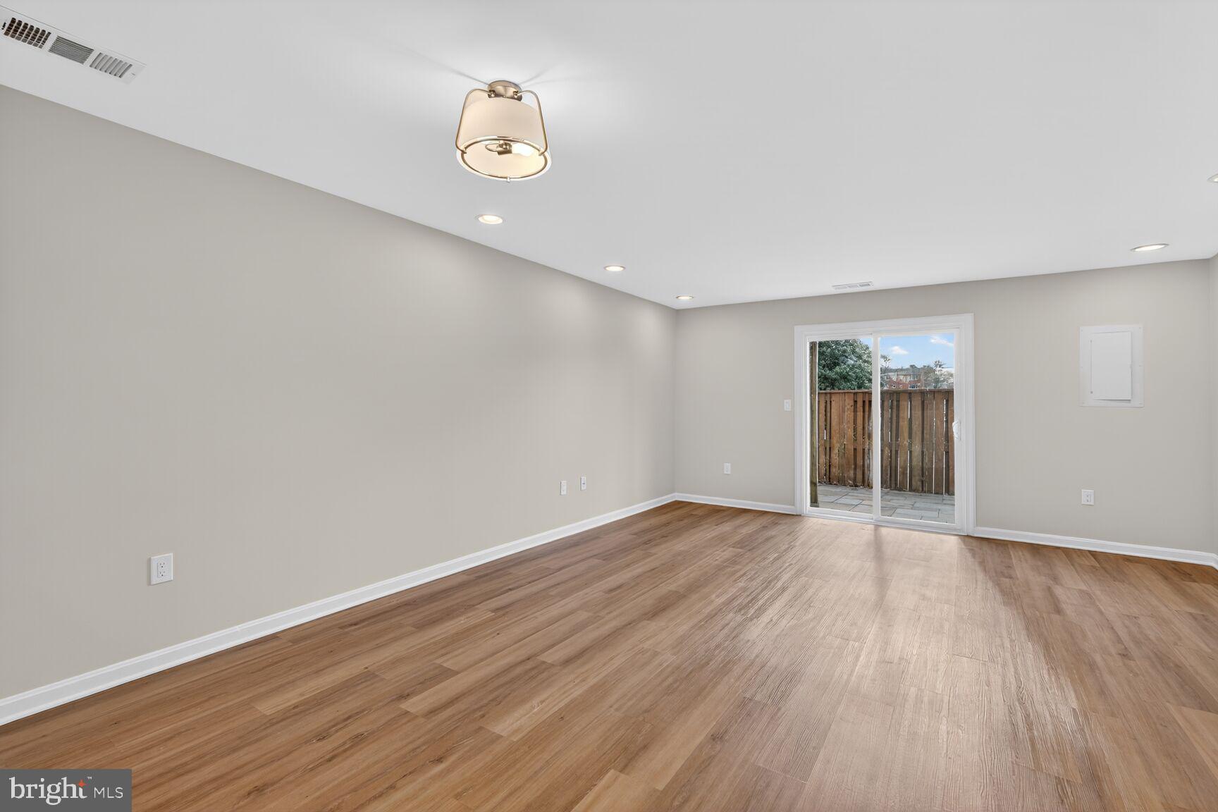 3854 9th Road South, Unit 3854 Arlington, VA 22204 - Photo 12 of 31 a view of an empty room with wooden floor and a window