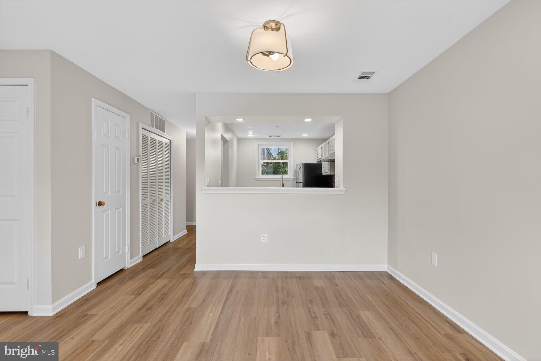 3854 9th Road South, Unit 3854 Arlington, VA 22204 - Photo 14 of 31 a view of a big room with wooden floor and windows