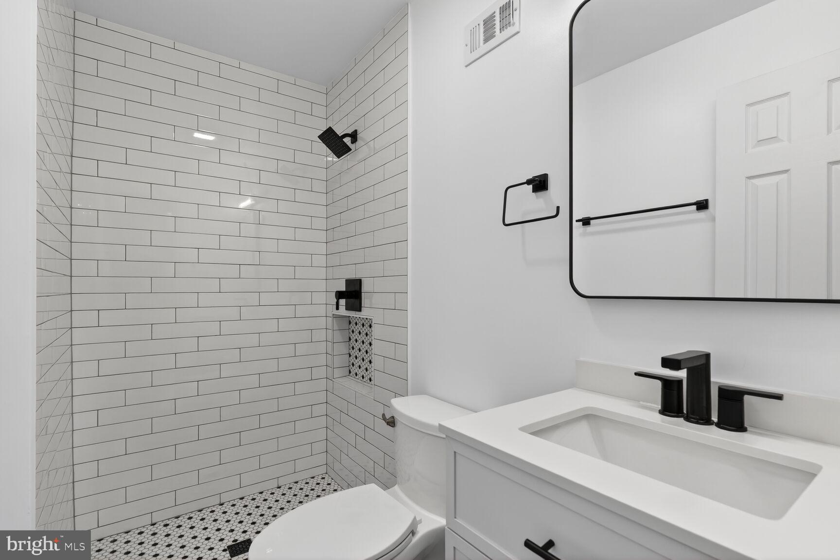 3854 9th Road South, Unit 3854 Arlington, VA 22204 - Photo 22 of 31 a bathroom with a sink a toilet and shower