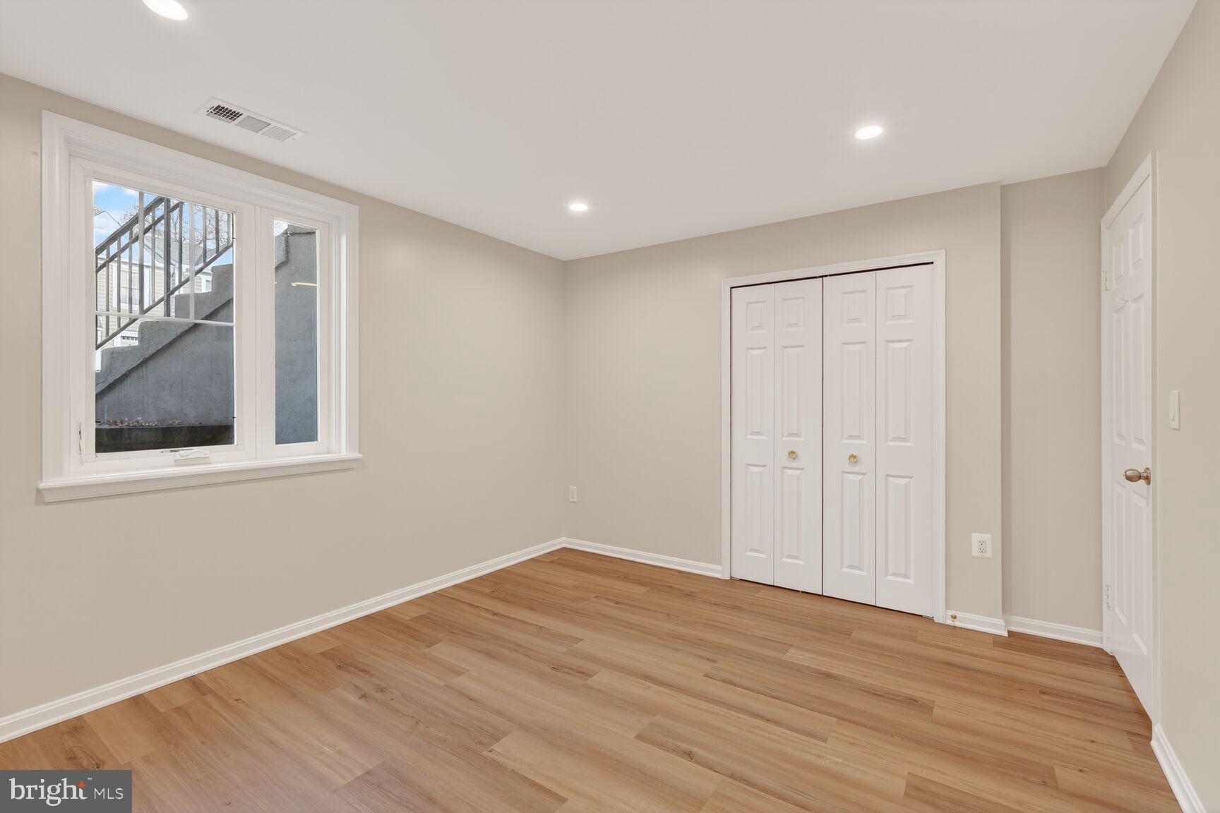 3854 9th Road South, Unit 3854 Arlington, VA 22204 - Photo 24 of 31 a big room with wooden floor and windows