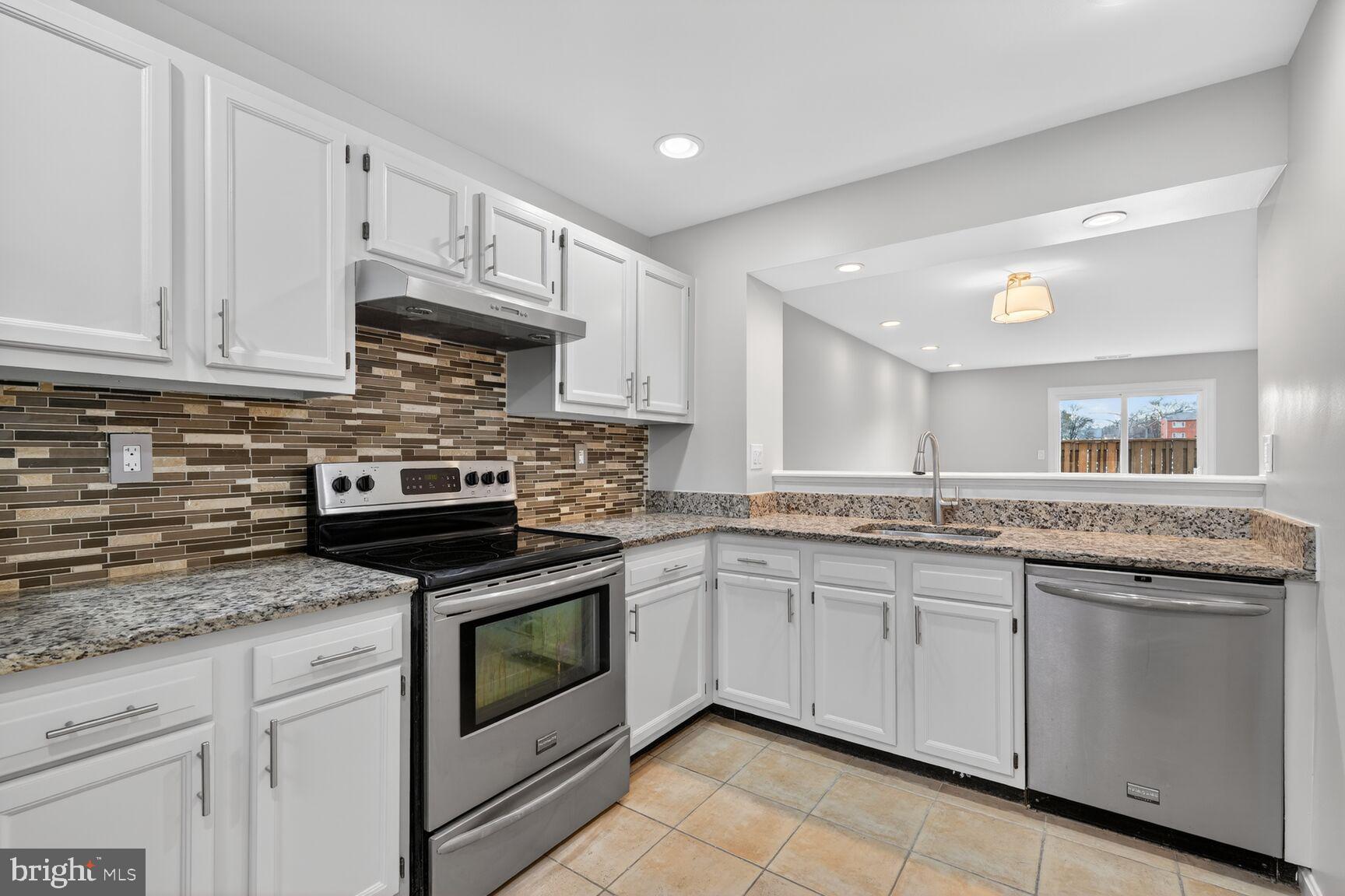 3854 9th Road South, Unit 3854 Arlington, VA 22204 - Photo 8 of 31 a kitchen with granite countertop stainless steel appliances white cabinets granite counter tops and a sink