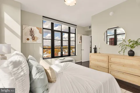 a bedroom with a large bed and a window