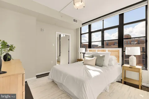 a bedroom with a large bed and a window