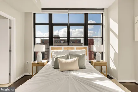 a bedroom with a large bed and a large window