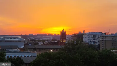a view of a house with a yard and a street