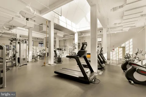 a room with pool table and windows