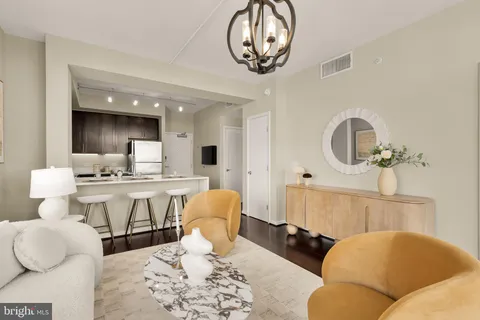 a living room with a couch and chandelier