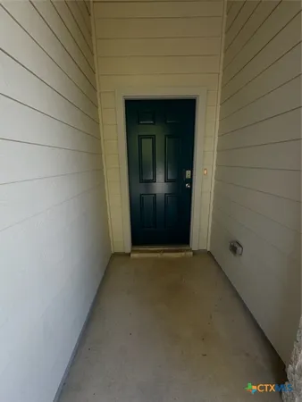 a view of kitchen with stainless steel appliances granite countertop cabinets and wooden floor