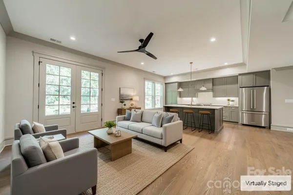 a large white kitchen with a large island in the center