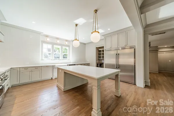 a kitchen with a refrigerator a sink and cabinets