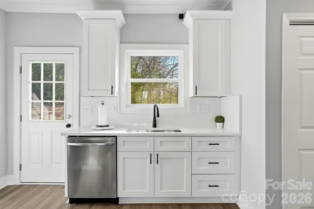 a kitchen with stainless steel appliances cabinets and a window