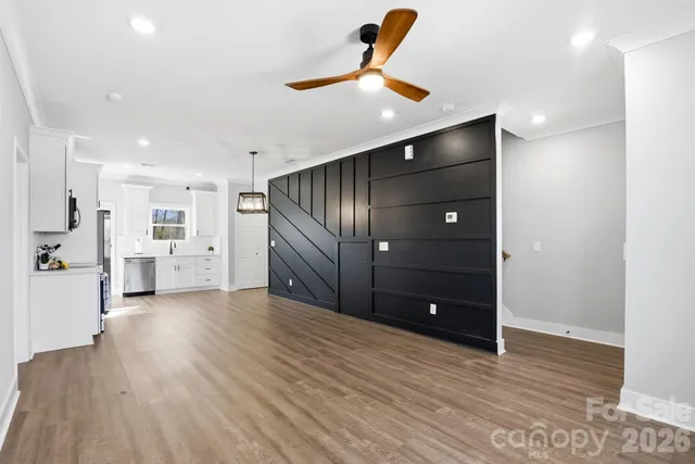 a view of an empty room with wooden floor
