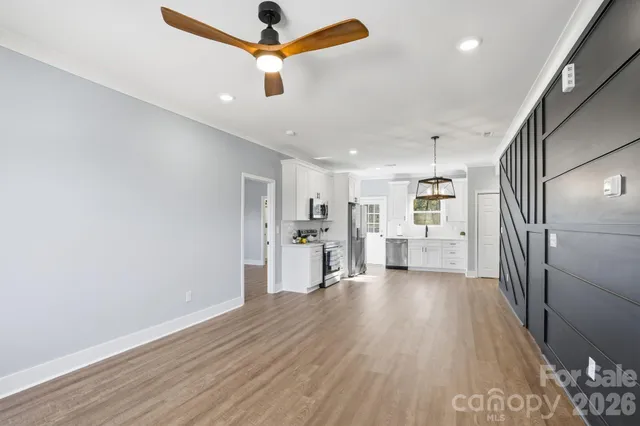 a view of a kitchen with a sink and wooden floor