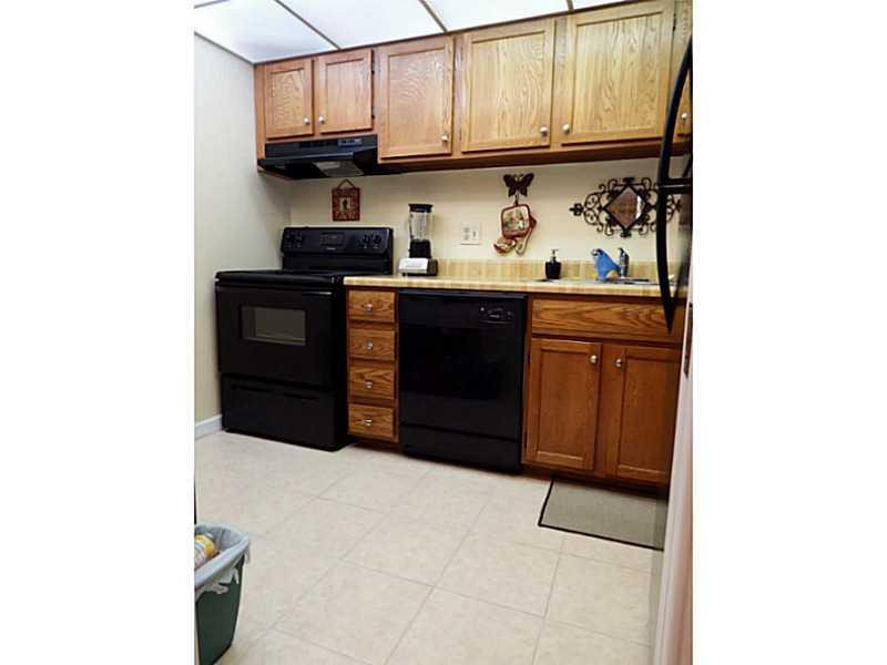 3750 Inverrary Drive, Unit 2Q Lauderhill, FL 33319 - Photo 1 of 16 a kitchen with stainless steel appliances granite countertop a refrigerator and a stove