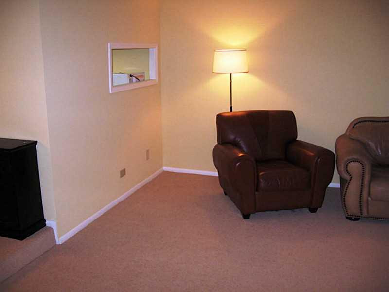 3750 Inverrary Drive, Unit 2Q Lauderhill, FL 33319 - Photo 11 of 16 a living room with furniture and a lamp
