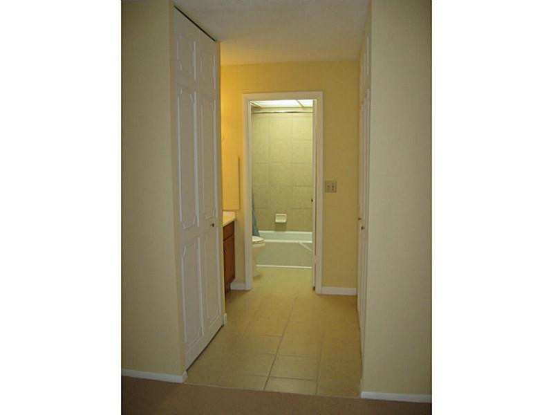 3750 Inverrary Drive, Unit 2Q Lauderhill, FL 33319 - Photo 12 of 16 a bathroom with a glass door shower