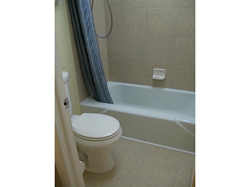3750 Inverrary Drive, Unit 2Q Lauderhill, FL 33319 - Photo 13 of 16 a bathroom with a toilet and a shower