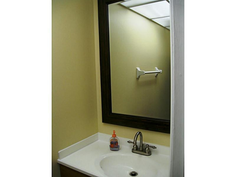 3750 Inverrary Drive, Unit 2Q Lauderhill, FL 33319 - Photo 16 of 16 a bathroom with a sink and a mirror