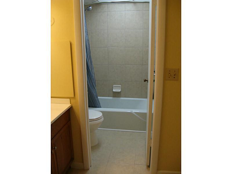 3750 Inverrary Drive, Unit 2Q Lauderhill, FL 33319 - Photo 5 of 16 a bathroom with a bathtub and shower
