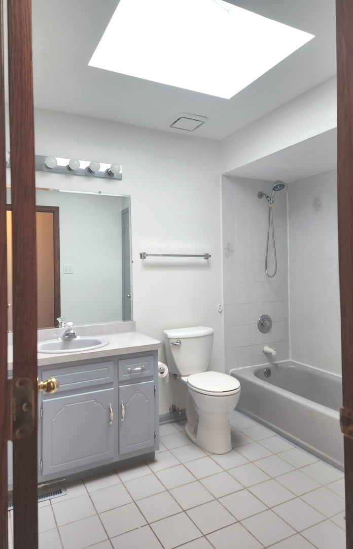 11723 South Ave J Chicago, IL 60617 - Photo 17 of 32 a bathroom with a sink a toilet and shower