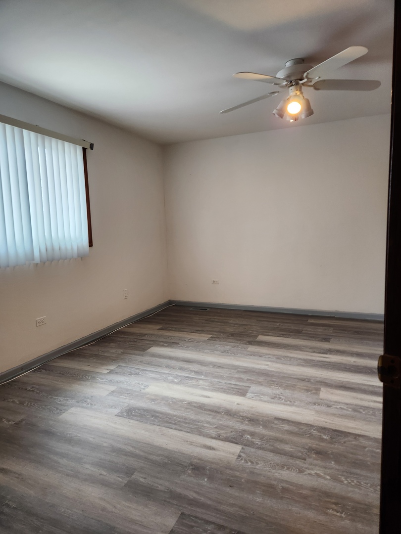 11723 South Ave J Chicago, IL 60617 - Photo 19 of 32 a view of an empty room with a window