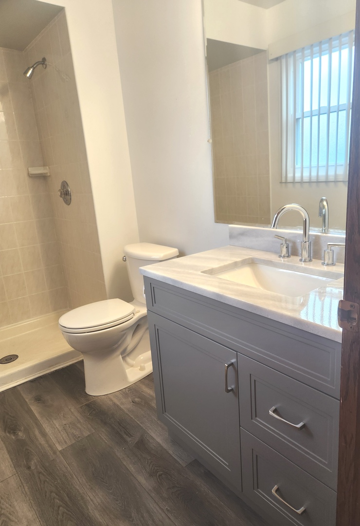 11723 South Ave J Chicago, IL 60617 - Photo 22 of 32 a bathroom with a sink a toilet and window