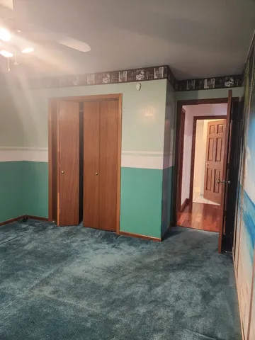 an empty room with closet and entrance