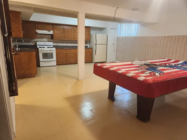 a kitchen with stainless steel appliances granite countertop a sink refrigerator and cabinets