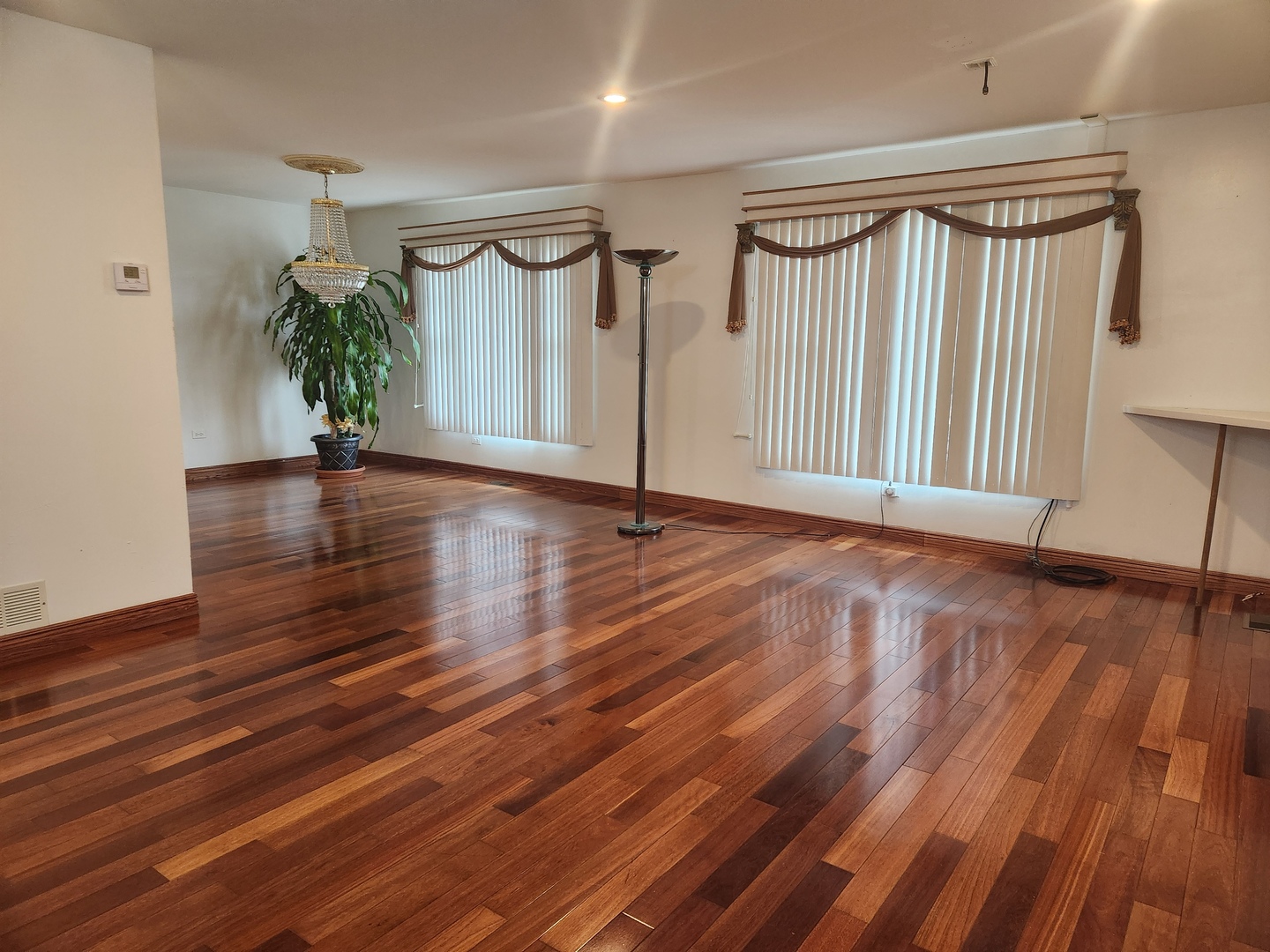 11723 South Ave J Chicago, IL 60617 - Photo 8 of 32 a view of an empty room with wooden floor and a window
