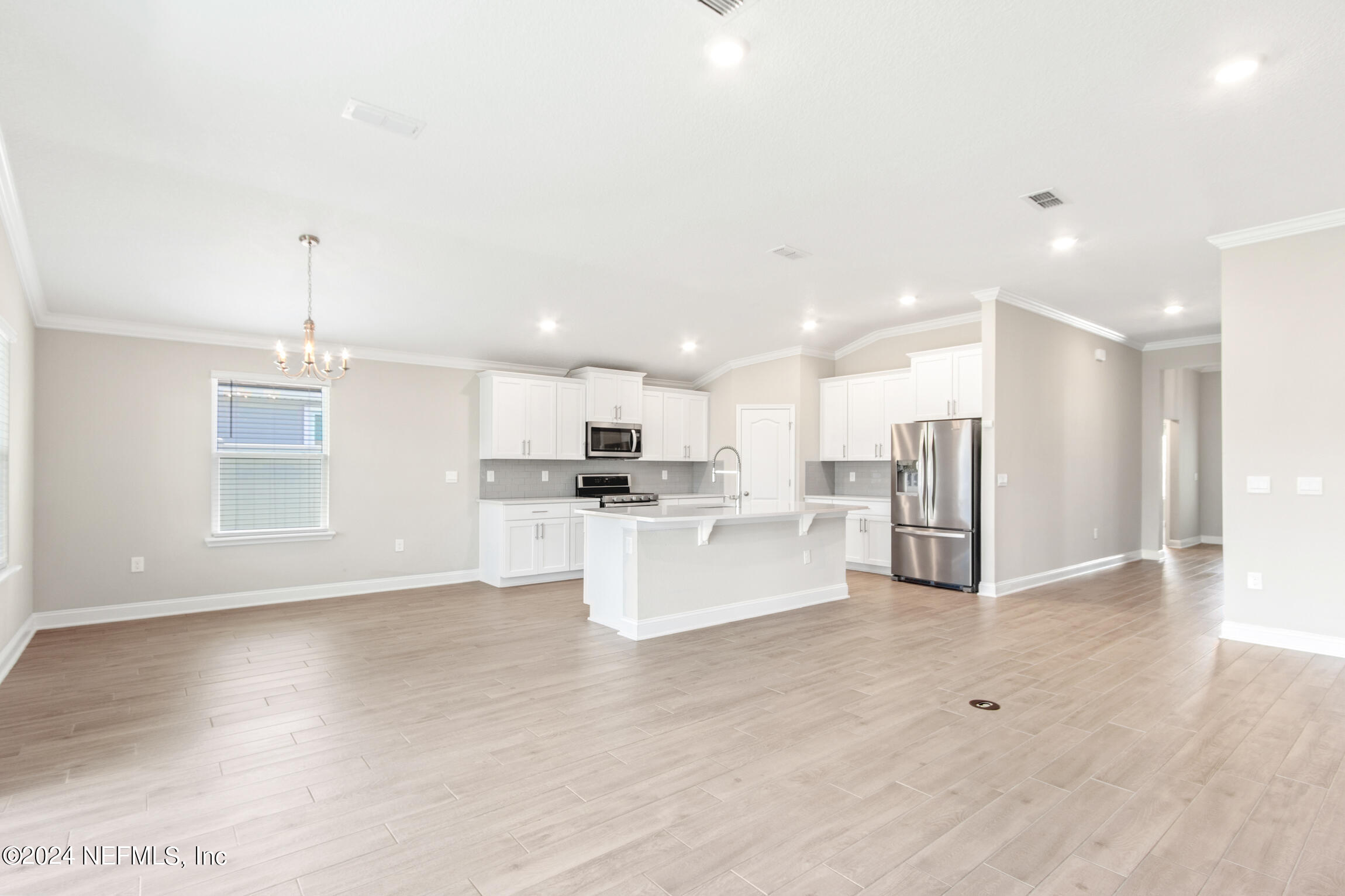 254 Ebro Road St. Augustine, FL 32084 - Photo 11 of 49 a view of kitchen with kitchen island white cabinets and refrigerator