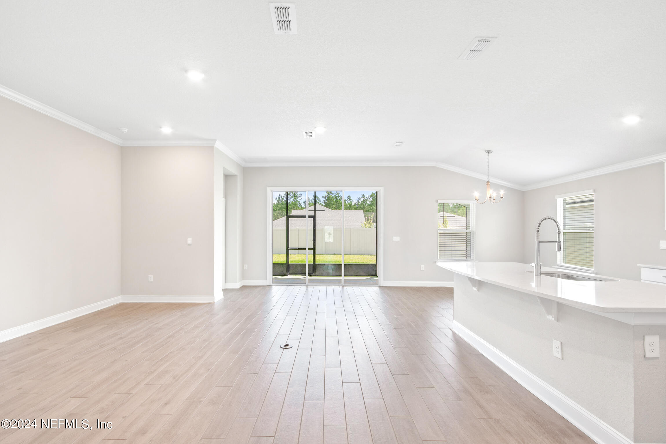 254 Ebro Road St. Augustine, FL 32084 - Photo 13 of 49 a view of an empty room with wooden floor and a window