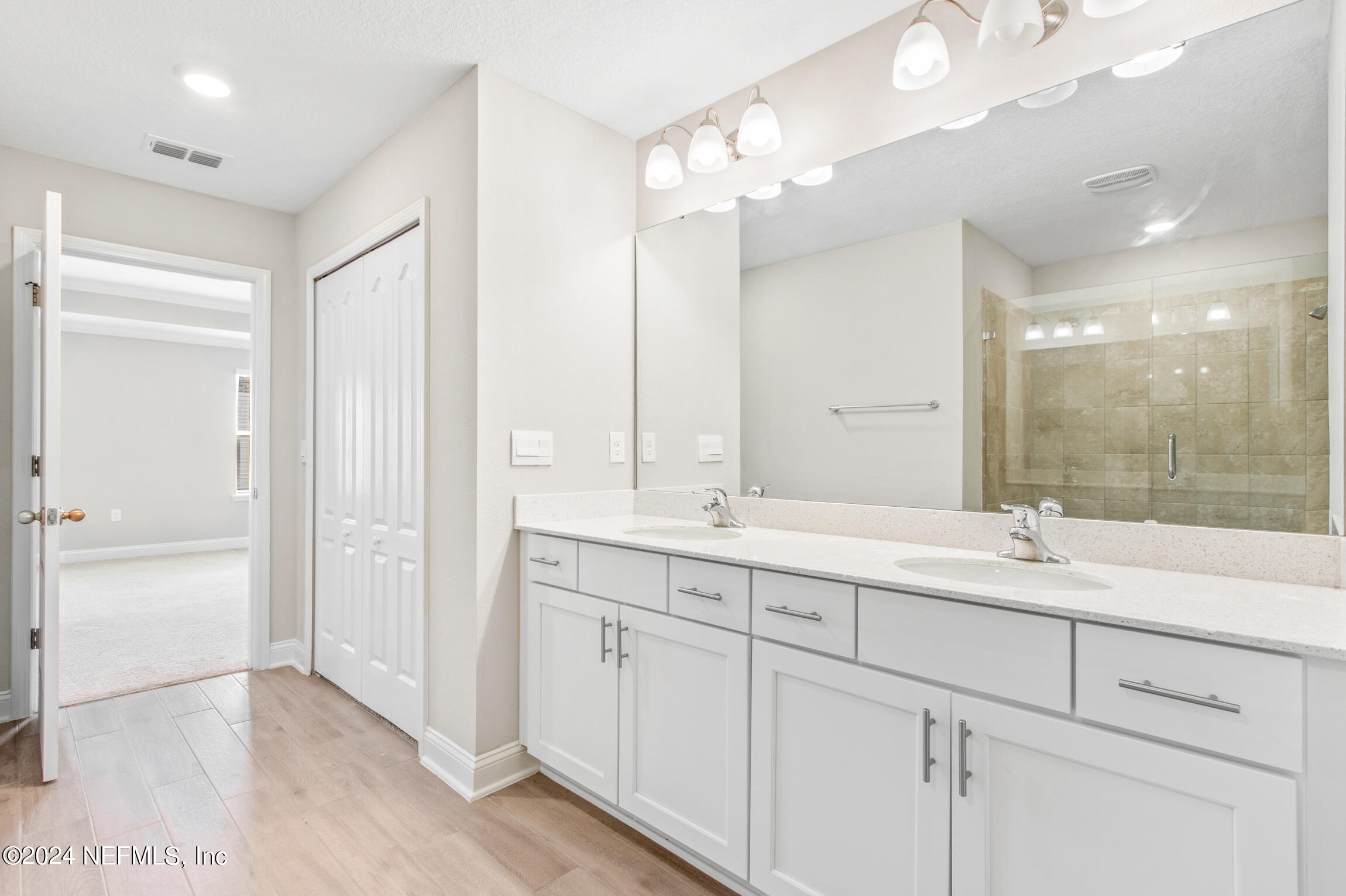 254 Ebro Road St. Augustine, FL 32084 - Photo 20 of 49 a bathroom with a double vanity sink mirror and double