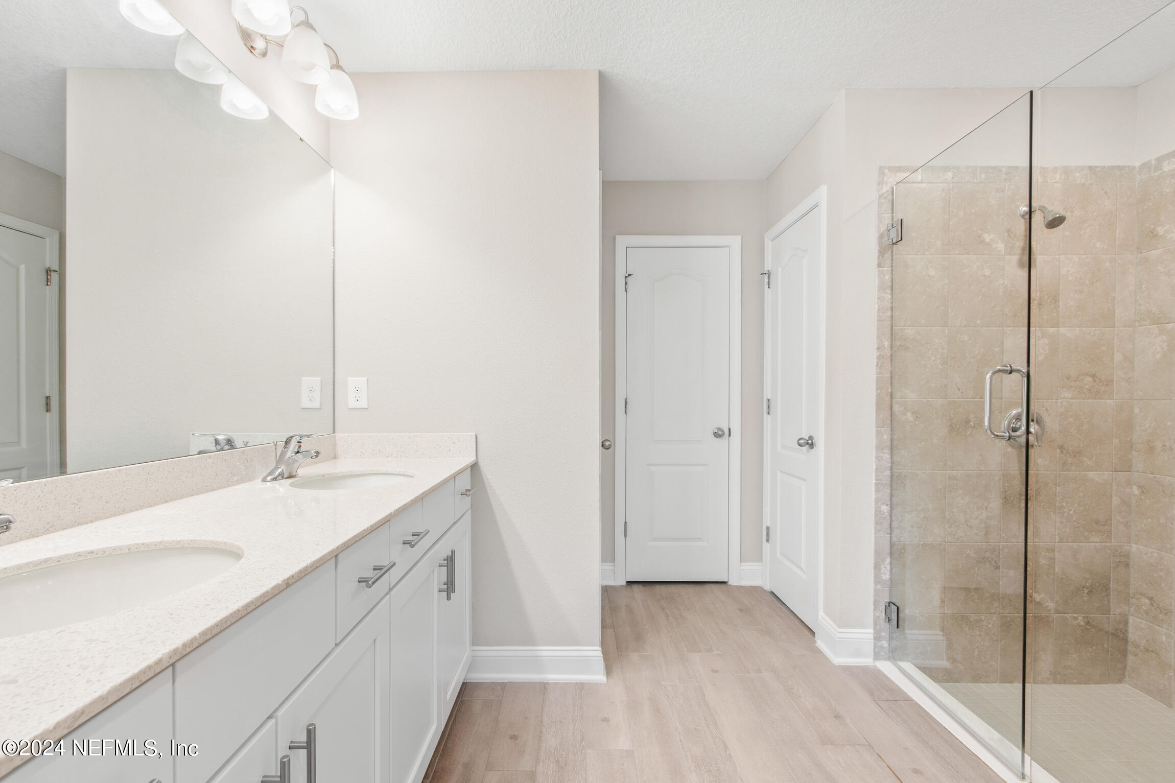 254 Ebro Road St. Augustine, FL 32084 - Photo 21 of 49 a spacious bathroom with a shower sink and mirror