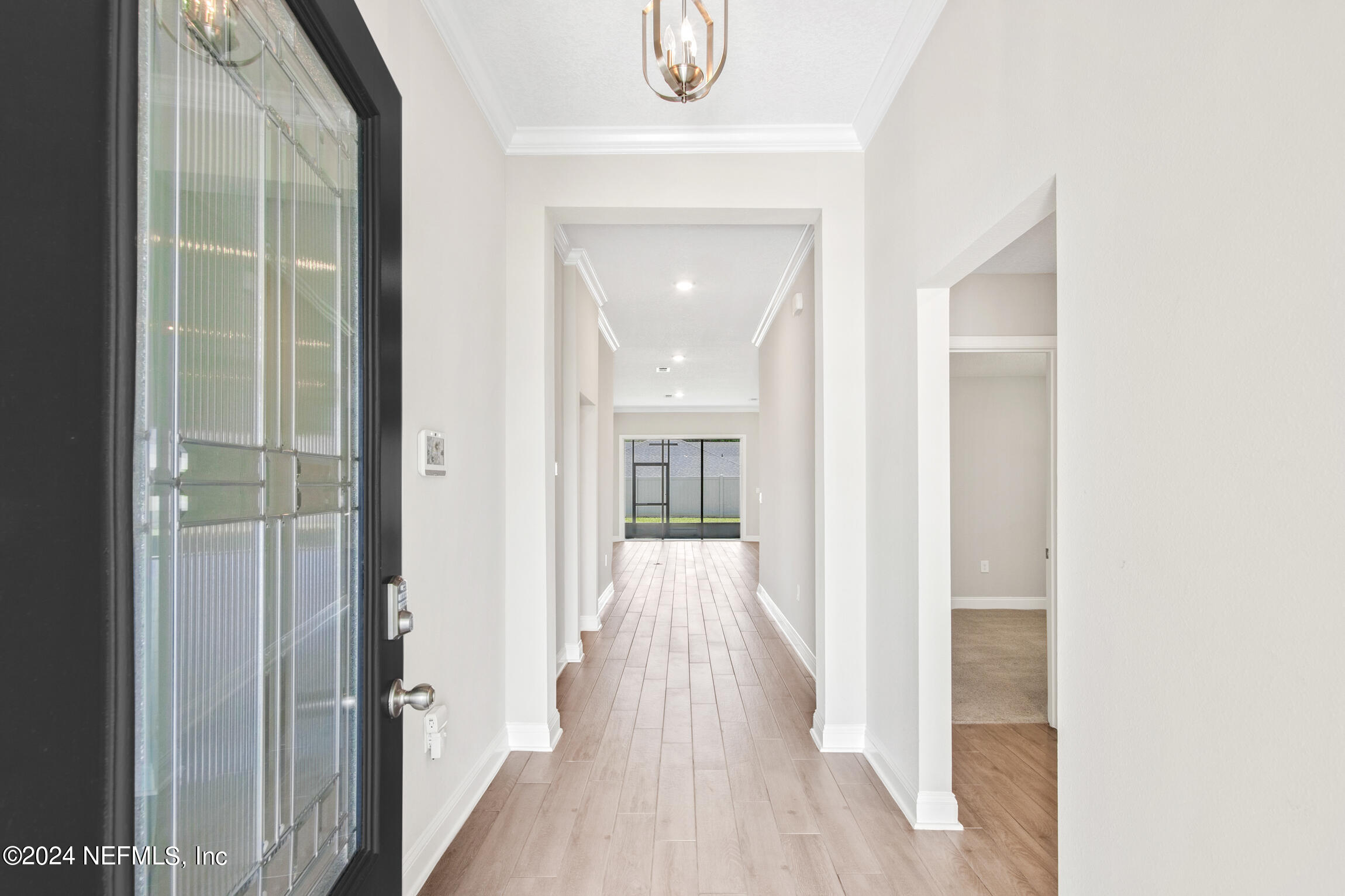 254 Ebro Road St. Augustine, FL 32084 - Photo 3 of 49 a view of a hallway with wooden floor