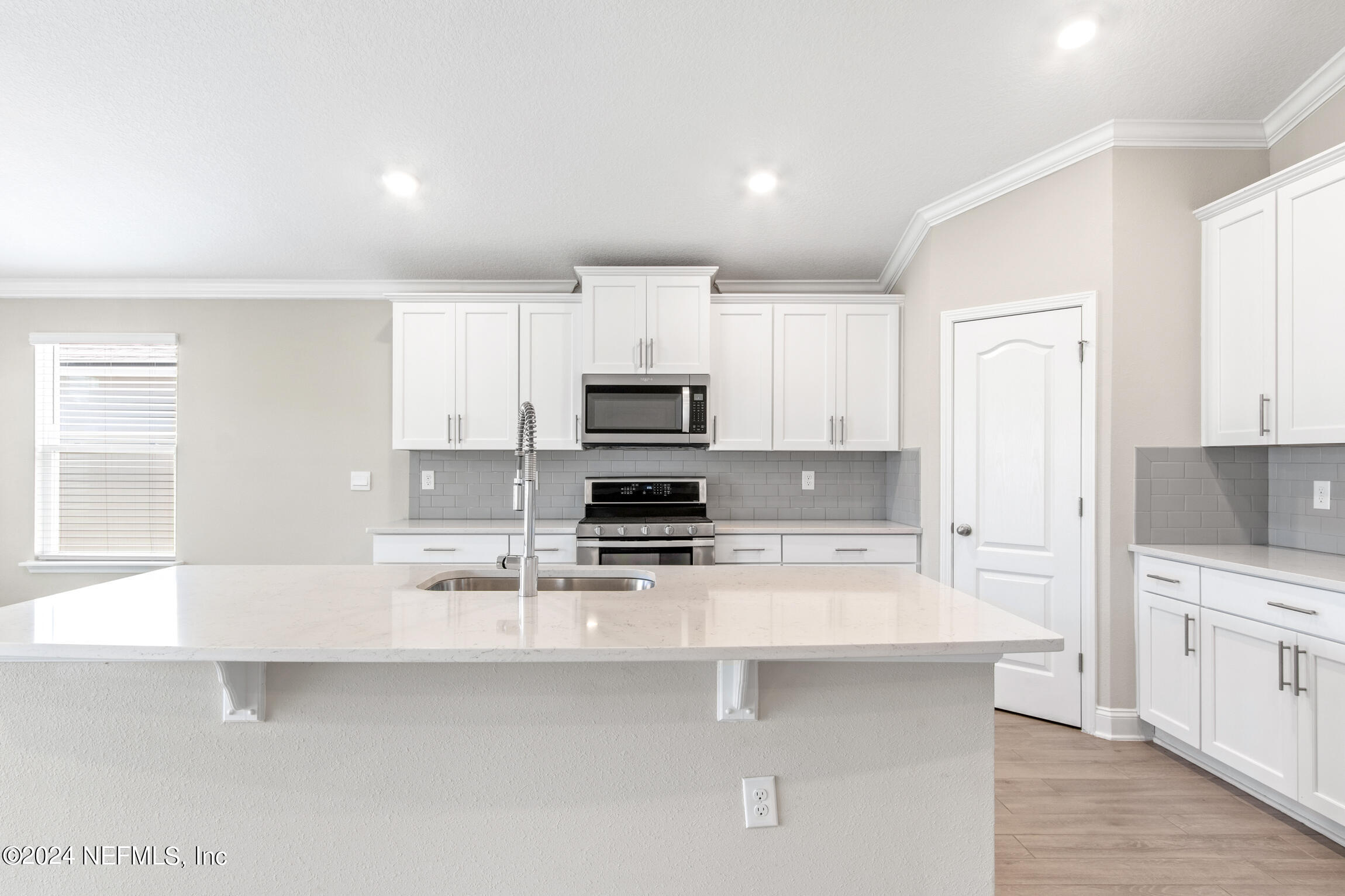 254 Ebro Road St. Augustine, FL 32084 - Photo 6 of 49 a kitchen with white cabinets and stainless steel appliances