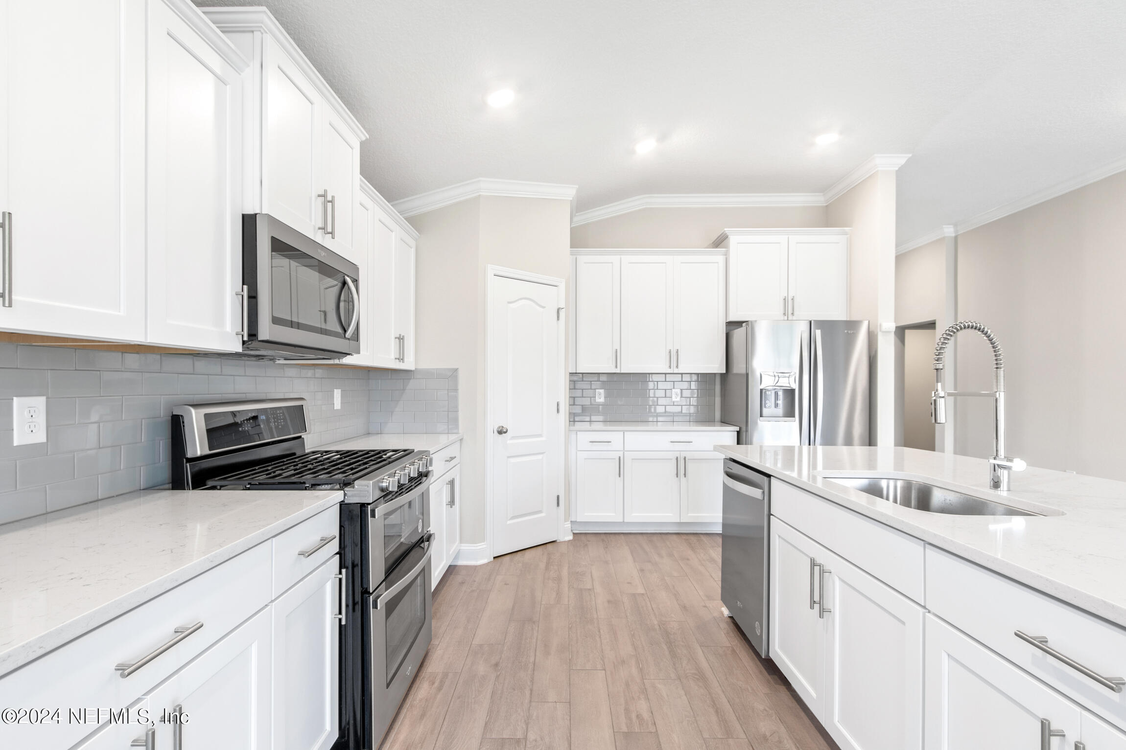 254 Ebro Road St. Augustine, FL 32084 - Photo 7 of 49 a kitchen with a sink stove top oven and cabinets