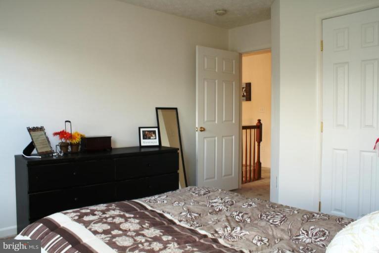 5627 New Forge Road White Marsh, MD 21162 - Photo 14 of 30 a bedroom with a bed and a dresser