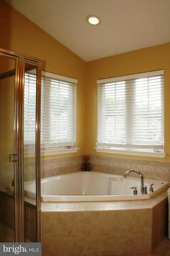 5627 New Forge Road White Marsh, MD 21162 - Photo 15 of 30 a bathroom with a bathtub and a shower