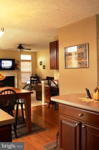 5627 New Forge Road White Marsh, MD 21162 - Photo 22 of 30 a open kitchen with stainless steel appliances wooden floor dining table and chairs