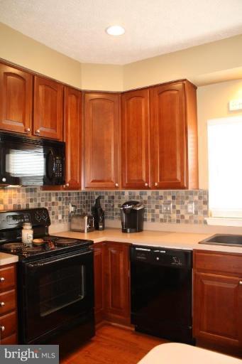 5627 New Forge Road White Marsh, MD 21162 - Photo 23 of 30 a kitchen with a sink a stove and cabinets