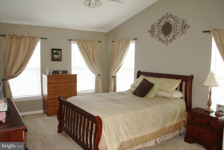 5627 New Forge Road White Marsh, MD 21162 - Photo 24 of 30 a bedroom with a bed and wooden floor