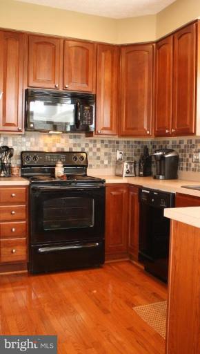 5627 New Forge Road White Marsh, MD 21162 - Photo 26 of 30 a kitchen with stainless steel appliances a stove a sink and a microwave