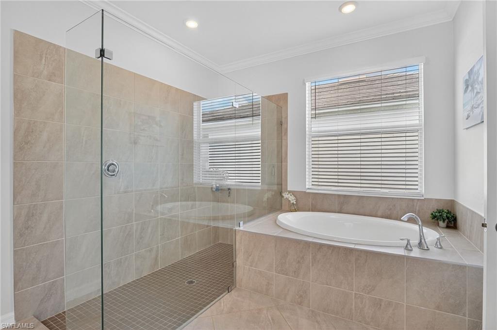 2130 Hamlin Street Naples, FL 34120 - Photo 14 of 43 a spacious bathroom with a granite countertop tub shower and a sink
