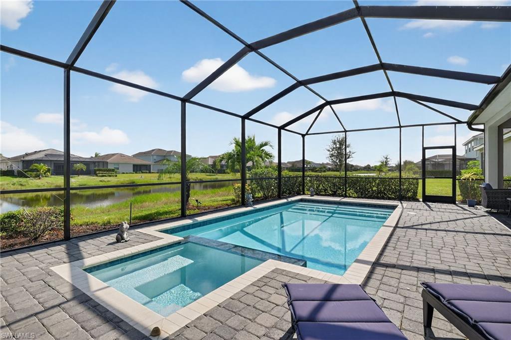 2130 Hamlin Street Naples, FL 34120 - Photo 28 of 43 a view of a patio with a table chairs and a swimming pool