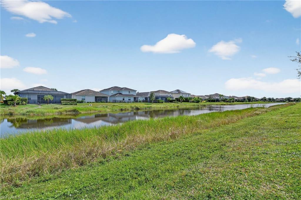2130 Hamlin Street Naples, FL 34120 - Photo 34 of 43 a view of a lake with houses in the back