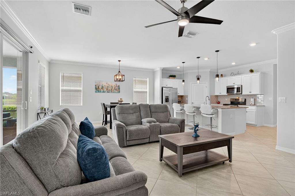 2130 Hamlin Street Naples, FL 34120 - Photo 8 of 43 a living room with furniture kitchen and a chandelier