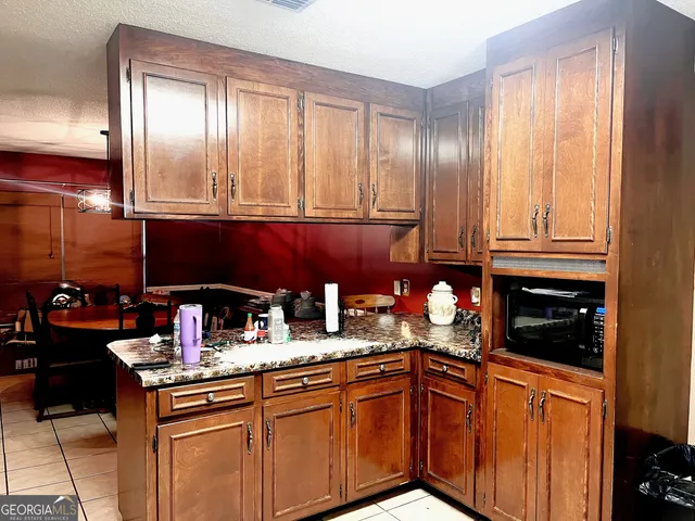 a kitchen with stainless steel appliances granite countertop a sink stove and cabinets